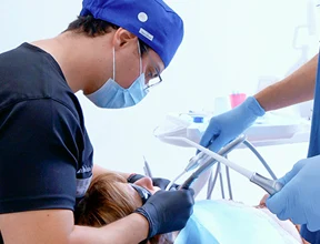 Professional specialist performing an affordable, high-quality oral procedure inside a modern dental clinic.